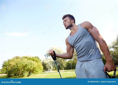 Young Man Exercising With Expander In Summer Park Stock Photo Image