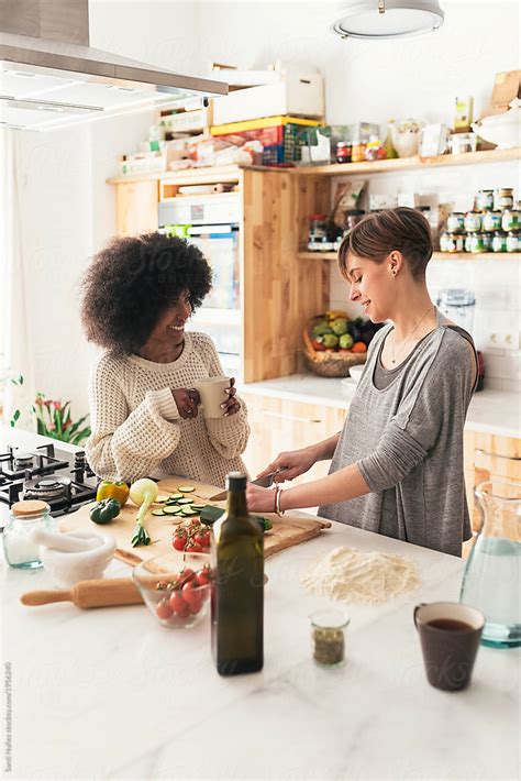 Two Beautiful Girls Cooking In In The Kitchen At Home By Stocksy Contributor Santi Nuñez