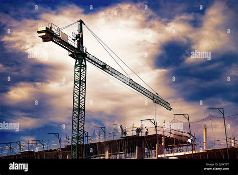 Sunset Landscape And Construction Cranes And Buildings Construct With