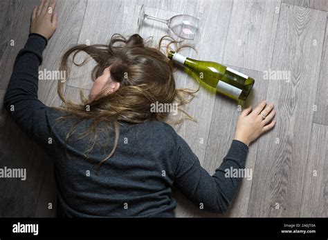 Drunk Alcoholic Young Girl Lying On The Floor Feeling Sick By Drinking