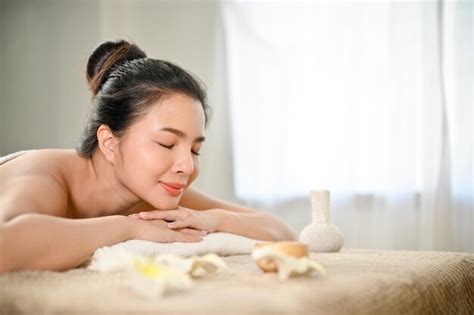 Premium Photo Calm Young Asian Woman Relaxing On Massage Table In Spa Salon Wellness Body Care