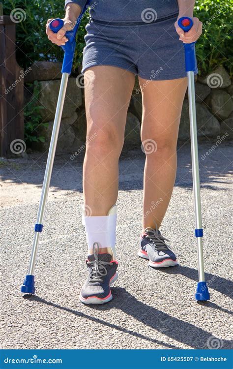 Person With Ankle Brace Walking With Crutches Stock Image Image Of