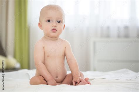 Cute Naked Baby Babe Sitting On Bed Stock Photo Adobe Stock