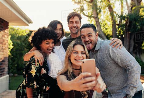 Group Of People Partying Together And Taking Selfie Young Friends At Housewarming Party Taking