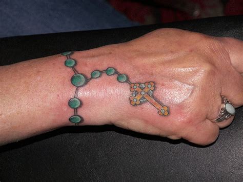 Black christian cross tattoo on wrist. Bracelet Tattoos Designs, Ideas and Meaning | Tattoos For You