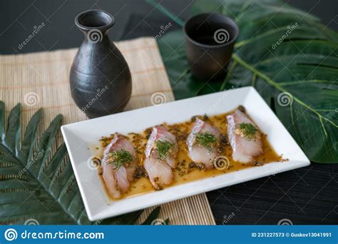 Sea Bass Sashimi With Sauce On White Plate Black Decanter With Sake Stock Image Image Of Chef