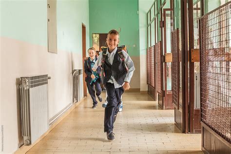 Boys Running Down The School Hallway By Stocksy Contributor Mosuno