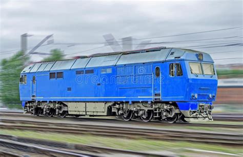 Blue Locomotive Diesel Train At High Speed Rides By Rail Stock Photo