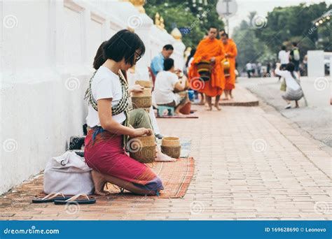 laotian girl setting out rice cakes to dry in vientianne editorial photo