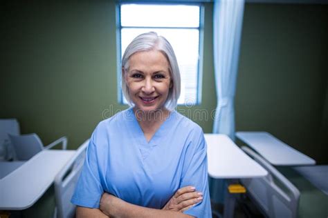 Portrait Of Nurse Standing With Arms Crossed Stock Photo Image Of
