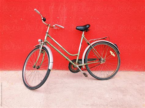 Retro Bike Leaning On The Red Wall By Stocksy Contributor Brkati