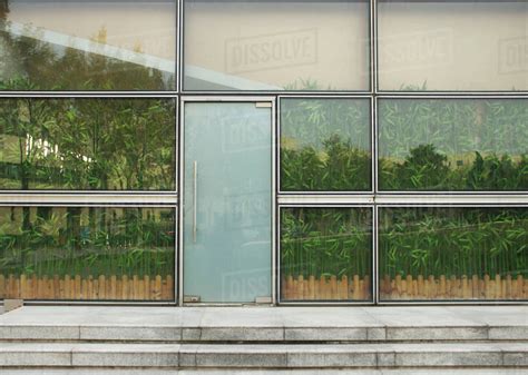 Reflection Of Trees In Glass Windows Stock Photo Dissolve