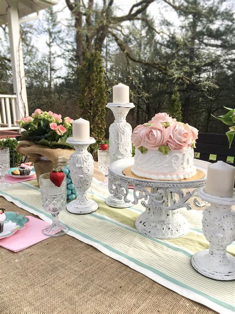 An assortment of colorful flowers along with berry clusters and shimmering easter eggs adorn the woven branch tree. Creative Outdoor Dining Easter Brunch Ideas ~ Hallstrom Home