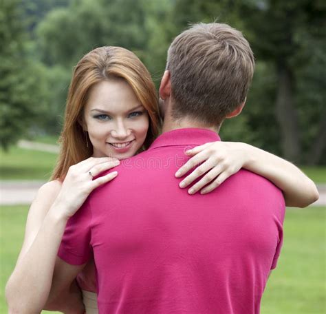 Young Woman Hugging Her Boyfriend Stock Photo Image Of Carefree
