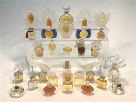 Lot A Collection Of Twenty Four Lalique Miniature Perfume Bottles