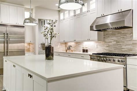 Quartz kitchen countertops with white cabinets, cherry cabinets, sink, backsplash, and pictures. Enhance Your Modern Kitchen with White Quartz Countertops