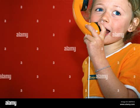 Little Girl Talking Into Toy Telephone Stock Photo Alamy