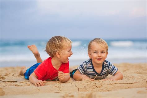 Two Young Boys Having Fun On A Beach Happy Friends Laughing Stock