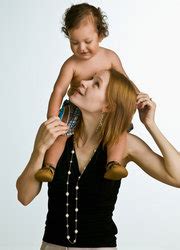 Mother carrying son on shoulders stock photo
