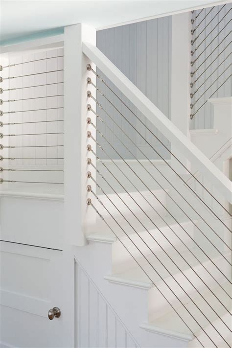 An Open Door With White Railings Next To A Set Of Stairs In A Home