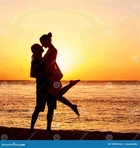 Romantic Couple On The Beach At Colorful Sunset On Background Stock