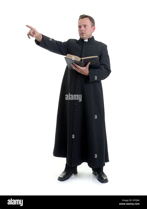 Catholic Priest Preaching Holding Open The Bible Book Shot On White