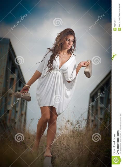 Attractive Woman With Short White Dress And Long Hair