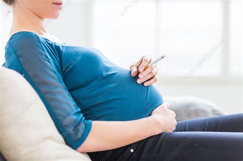 pregnant woman smoking a cigarette stock image c035 2156 science photo library