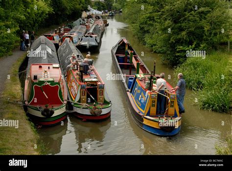 British Waterways Working Narrowboat Passing Other Working Boats Under Canvas Breasted Up On