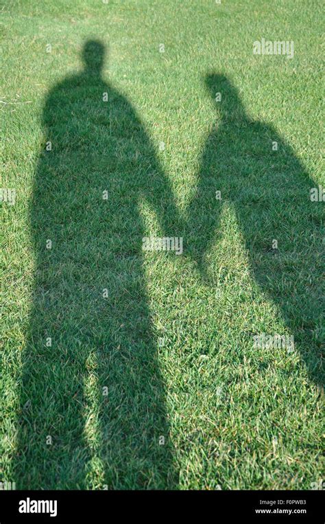 Shadow Of Couple Holding Hands Uk Stock Photo Alamy
