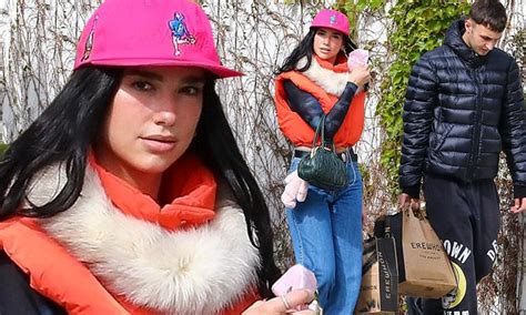Dua Lipa Goes Bold In Puffy Orange Vest As She Makes Grocery Run With