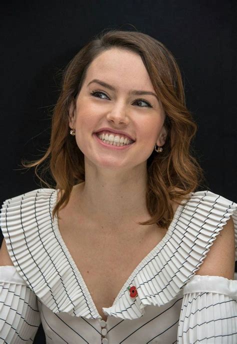 a woman in a white dress smiling at the camera