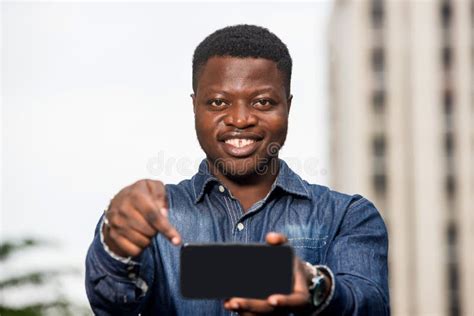 Portrait Of Young African Man With Mobile Phone Happy Stock Photo