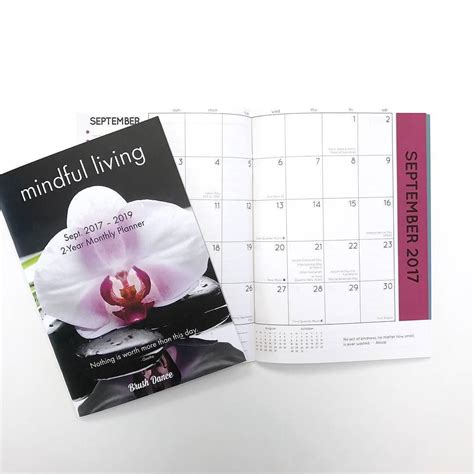 A Calendar With A Flower On It And A Book About Mindful Living Written