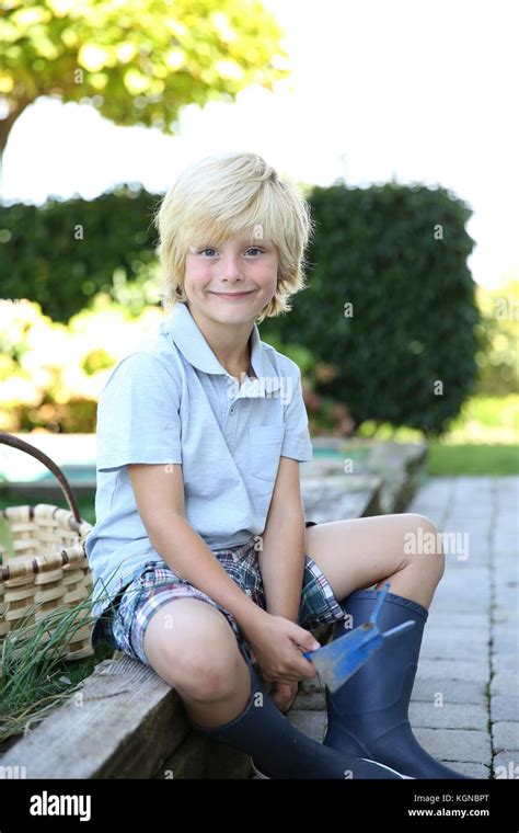 Portrait Of Cute 7 Year Old Boy In Vegetable Garden Stock Photo Alamy