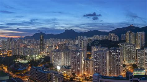 Panorama Of Hong Kong City Skyline And Lion Rock Hill At Dusk Stock