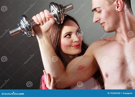 Couple Muscular Man And Girl Admiring His Strength Stock Photo Image