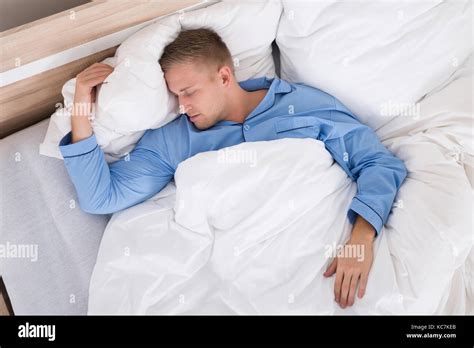 Young Man Sleeping Peacefully At Home In His Bed Stock Photo Alamy