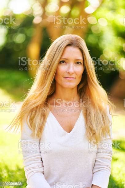 Beautiful Mature Woman Posing Outside In A Sunny Park Or Garden Stock