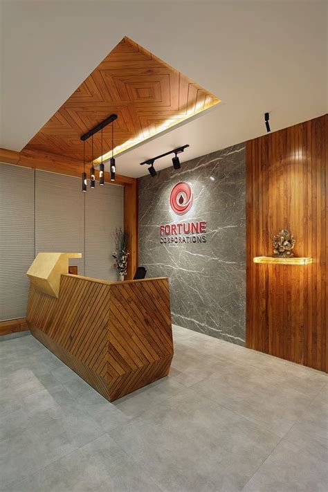 An Office Lobby With Wood Paneling And Marble Counter Tops Along With