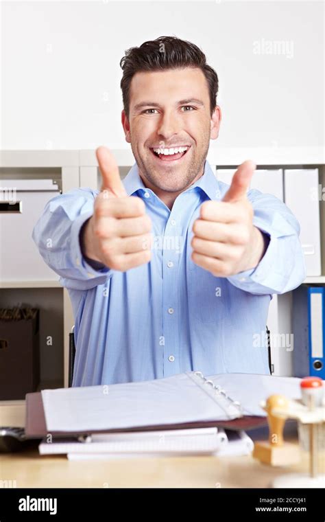 Cheering Manager In The Office Holds Both Thumbs Up Stock Photo Alamy