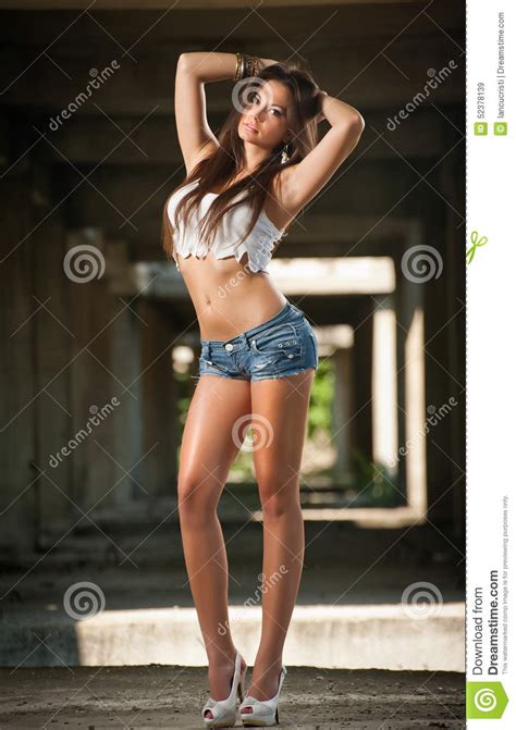 Portrait Of A Beautiful Woman With Denim Shorts And White