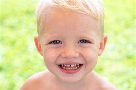 Premium Photo Close Up Portrait Of Happy Smiling Child Boy On Green