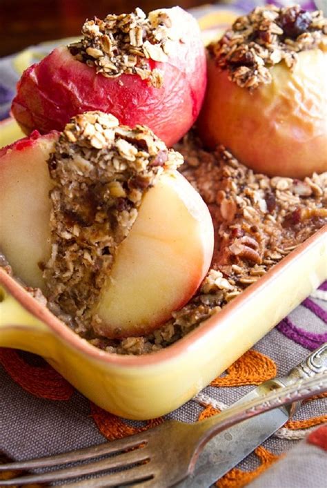 Two Apples And Some Granola In A Yellow Dish On A Table With A Fork