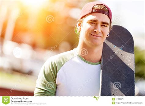 Teenage Boy With Skateboard Standing Outdoors Stock Image Image Of