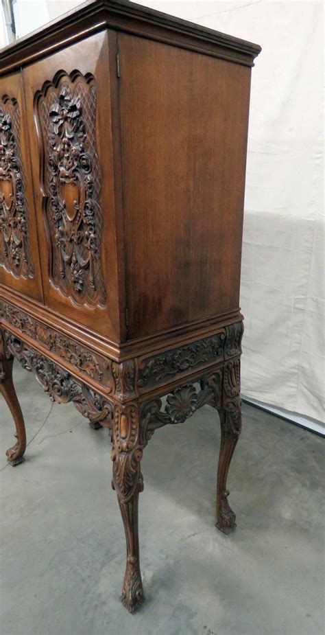 Entertainers, you might want to pay attention to this one. Victorian Style Carved Liquor Cabinet For Sale at 1stdibs