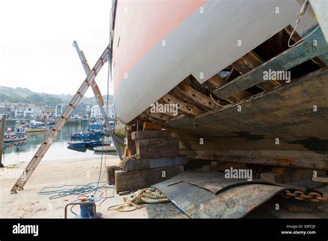 Traditional Wooden Fishing Boat Being Repaired Whilst Out Of The Water