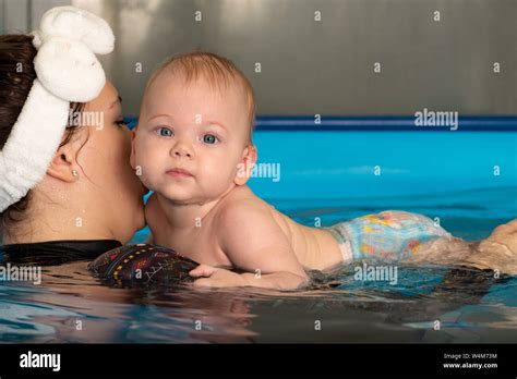 Infant Swimming Baby Girl Swimming In A Pool Stock Photo Alamy