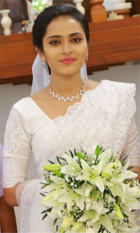 A Woman In A Wedding Dress Holding A Bouquet