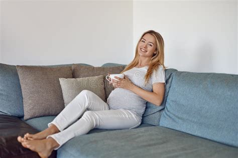 Pretty Barefoot Young Pregnant Woman Relaxing On A Couch Stock Image Image Of Beautiful Home